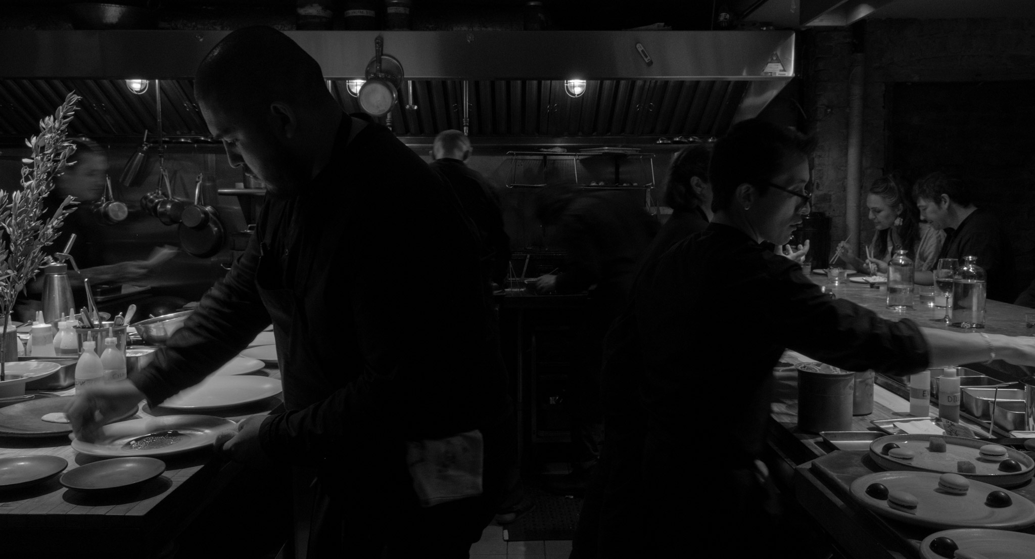 Corima open kitchen during service — chefs plating at the pass